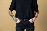 Tattooed model in black t shirt and jeans