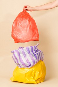 Colorful garbage bags isolated on yellow background