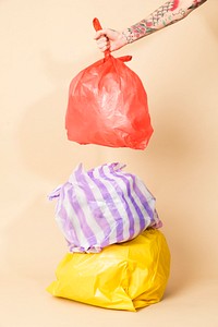 Colorful garbage bags isolated on yellow background