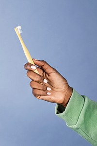 Black woman holding a toothbrush 