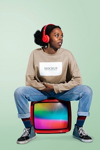 Black woman sitting on a retro television mockup