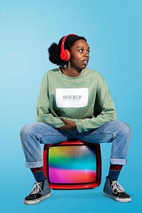 Black woman sitting on a retro television mockup