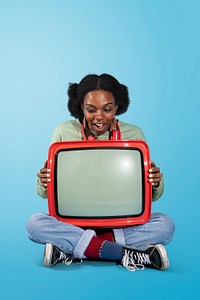 Black woman sitting with a retro television