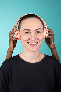 Shaved hair woman with pink headphones