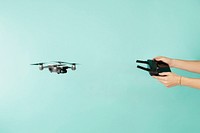 Hands holding remote controlling drone