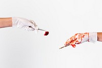 Hands holding a scalpel and a bloody cotton ball