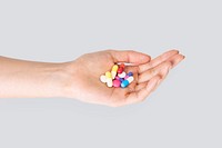 Hand taking pills treatment isolated