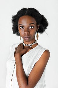 Confident black girl holding her necklace