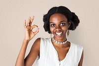 Happy black girl showing an ok hand gesture 