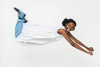 Cheerful African American woman in a flying pose