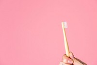 Toothbrush against a pink background 