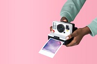 Hands holding an instant camera