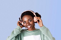 Black woman enjoying the music with blue background