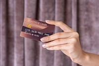 Feminine hand holding a credit card 