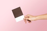 Feminine hand holding a color swatch