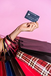 Woman carrying shopping bags and a credit card 
