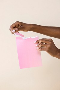 Black woman tearing a pink paper mockup 