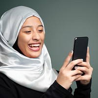 Portrait of a Muslim woman using a mobile phone