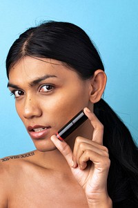 Closeup beautiful woman holding a lipstick