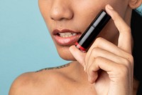 Closeup beautiful woman holding a lipstick