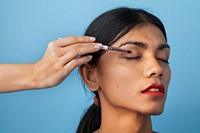 Makeup artist applying eyeshadow onto the model