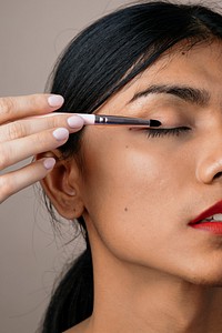 Closeup of beautiful woman holding an eyeshadow brush