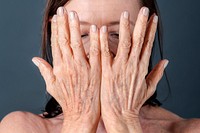 Close up of a senior woman with aging hands