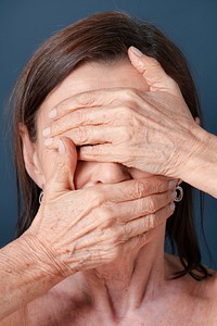 Close up of a senior woman covering her face