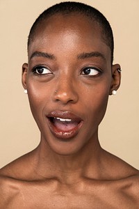 Black nude woman headshot on a beige background<br /> 