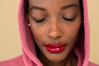 Black woman in a pink hoodie