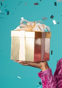 Happy black woman holding a gift box