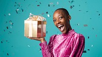 Happy black woman holding a gift box on green background