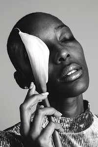 Portrait of a black woman with a white lily