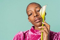 Portrait of a black woman with a white lily on blue background