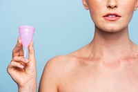 Woman holding pink menstrual cup