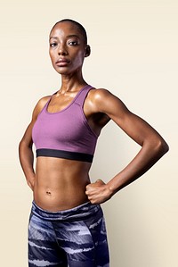 Black woman in sportswear on beige background