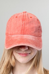 Happy woman wearing an orange cap