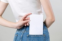 Woman keeping a blank flyer in her pants pocket