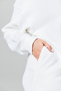 Hand the in white sweater pocket