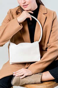 Woman with a white hand bag