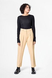 Stylish woman in black long sleeve tee and beige slacks casual wear fashion full body