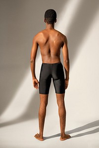 Man mockup in black swim shorts summer apparel full body rear view