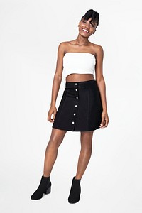 Woman in white bandeau top and black a-line skirt casual fashion full body
