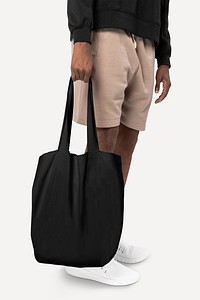 Man carrying black tote bag studio shoot