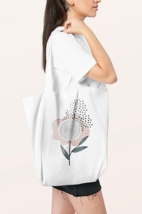 White tote bag psd mockup with floral design studio shoot
