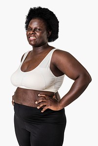 African American woman wearing sports bra and black yoga pants with confidence