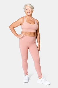 Healthy senior woman in pink sports bra and leggings full body