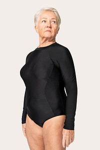 Mature woman in surfing swimsuit summer apparel on beige background