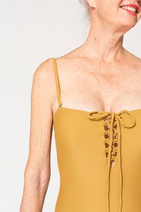 Yellow one-piece swimsuit mockup psd on senior woman closeup