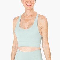 Healthy senior woman in mint green sports bra and leggings